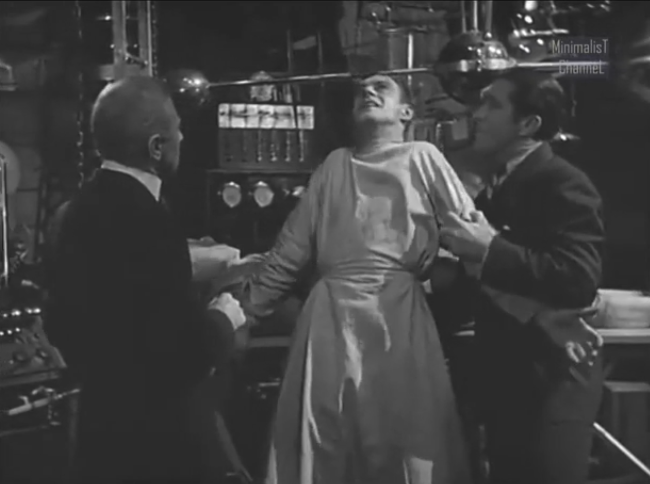 A figure in a laboratory looking a bit crazy, referencing the Frankenstein &ldquo;its alive&rdquo; scene